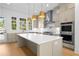 Gourmet kitchen featuring a large island, stainless steel appliances, and ample cabinet space at 415 Mayfair Ct, Alpharetta, GA 30009