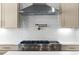 Gourmet kitchen featuring a stainless steel stove, pot filler, and stylish range hood at 415 Mayfair Ct, Alpharetta, GA 30009