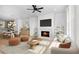 Open-concept living room with fireplace, modern furnishings, and adjacent dining area at 415 Mayfair Ct, Alpharetta, GA 30009