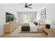 Modern main bedroom with designer decor, TV and beautiful natural lighting at 415 Mayfair Ct, Alpharetta, GA 30009