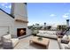 Luxurious roof deck with outdoor fireplace and comfortable seating area at 415 Mayfair Ct, Alpharetta, GA 30009