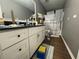 Bathroom featuring dark countertop, white cabinets, a large mirror, and shower and tub combination with patterned curtain at 4284 Village Green W Cir, Conyers, GA 30013