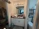 Bathroom boasting a black countertop, a large mirror with lights, a toilet, and closet with shelf at 4284 Village Green W Cir, Conyers, GA 30013