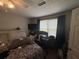 Bedroom with a white and gray patterned bedspread, a mounted TV, and a window with dark blue curtains at 4284 Village Green W Cir, Conyers, GA 30013