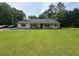 Charming single-story home with a large front lawn and inviting front porch at 4284 Village Green W Cir, Conyers, GA 30013