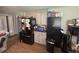 Kitchen with appliances, extra shelving, and adjacent dining area at 4284 Village Green W Cir, Conyers, GA 30013