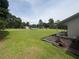 Spacious side yard showcasing a well-manicured lawn and an American style single Gathering home at 4284 Village Green W Cir, Conyers, GA 30013
