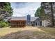 Backyard view of a home featuring a screened porch, a barbecue area, and mature trees at 5742 Riverside Walk Dr, Sugar Hill, GA 30518