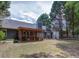 Spacious backyard features a screened-in porch, barbeque area, and lush greenery at 5742 Riverside Walk Dr, Sugar Hill, GA 30518