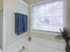 Bright bathroom features a tub with a garden window and lovely natural light at 5742 Riverside Walk Dr, Sugar Hill, GA 30518