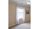 This bedroom shows a bright window with white curtains and light-colored walls and carpet at 5742 Riverside Walk Dr, Sugar Hill, GA 30518