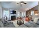 Spacious living room has vaulted ceiling, hardwood floors, and a cozy fireplace at 5742 Riverside Walk Dr, Sugar Hill, GA 30518