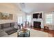 Cozy living room features a fireplace, a vaulted ceiling, and a hardwood floor at 5742 Riverside Walk Dr, Sugar Hill, GA 30518