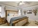Bright main bedroom with a trey ceiling, neutral walls, carpet floors, and a large bed with side tables at 5742 Riverside Walk Dr, Sugar Hill, GA 30518
