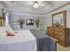 Spacious main bedroom features a trey ceiling, neutral walls, a large bed and generous closet space at 5742 Riverside Walk Dr, Sugar Hill, GA 30518