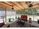 Inviting screened-in porch with wood ceiling, fans, outdoor furniture, and view of the backyard at 5742 Riverside Walk Dr, Sugar Hill, GA 30518