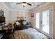 Comfortable sitting room with wood-look floors and access to the backyard at 5742 Riverside Walk Dr, Sugar Hill, GA 30518
