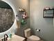 Cozy bathroom featuring decorative vanity, lighted mirror, and charming wall shelves at 11072 Shannon Cir, Hampton, GA 30228