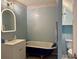 Bathroom featuring a stylish clawfoot tub, vanity with illuminated mirror, and modern fixtures at 11072 Shannon Cir, Hampton, GA 30228