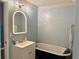 Bathroom featuring a stylish vanity with illuminated mirror and modern fixtures at 11072 Shannon Cir, Hampton, GA 30228