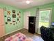 Charming bedroom featuring pastel-colored walls, ample natural light, and laminate flooring at 11072 Shannon Cir, Hampton, GA 30228