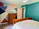 Vibrant bedroom featuring a queen bed, modern geometric wall decor, and laminate flooring at 11072 Shannon Cir, Hampton, GA 30228