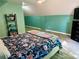 Bright bedroom features a queen bed, sloped ceilings, wood flooring, and ample natural light at 11072 Shannon Cir, Hampton, GA 30228