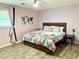 A lovely bedroom featuring laminate flooring, a decorative quilt, and ample natural light at 11072 Shannon Cir, Hampton, GA 30228