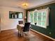 Dining room featuring a table for two, a large window, and hardwood floors at 11072 Shannon Cir, Hampton, GA 30228