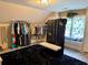 Well-organized dressing room featuring sloped ceilings, carpet, ample closet space and window seat at 11072 Shannon Cir, Hampton, GA 30228