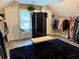 Spacious dressing room featuring carpet, sloped ceilings, organized racks and window seat with pillows at 11072 Shannon Cir, Hampton, GA 30228