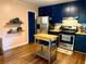 Functional kitchen features blue cabinets, butcher block countertops, and stainless steel appliances at 11072 Shannon Cir, Hampton, GA 30228