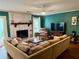 Comfortable living room with a fireplace, a sectional couch, and a large window at 11072 Shannon Cir, Hampton, GA 30228
