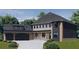 Stunning two-story home with a three-car garage, brick and siding details, and a covered front porch at 1330 Twelve Oaks Nw Cir, Atlanta, GA 30327