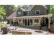 Inviting back exterior with an expansive patio, a stone fire pit, and a covered seating area at 4320 Oklahoma Nw Way, Kennesaw, GA 30152