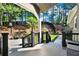 Multi-level backyard featuring lush landscaping, a black fence, and mature trees at 4320 Oklahoma Nw Way, Kennesaw, GA 30152