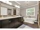 Modern bathroom featuring a soaking tub, double vanity, and large mirror with great lighting at 4320 Oklahoma Nw Way, Kennesaw, GA 30152