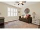 This bedroom features a window with shutters, an accent rug, and a ceiling fan at 4320 Oklahoma Nw Way, Kennesaw, GA 30152