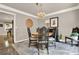 The dining room features a round table, decorative chairs, and a vintage chandelier at 4320 Oklahoma Nw Way, Kennesaw, GA 30152