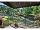 Charming front porch featuring wrought iron railings, stone floors, and a manicured lawn at 4320 Oklahoma Nw Way, Kennesaw, GA 30152