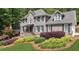 Beautiful two-story home with manicured lawn, decorative shrubs, and stone accents on the front facade at 4320 Oklahoma Nw Way, Kennesaw, GA 30152