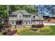 Charming two-story home featuring a landscaped front yard with vibrant shrubs and a stone facade entrance at 4320 Oklahoma Nw Way, Kennesaw, GA 30152