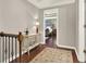 The hallway features hardwood floors, a console table, and a view into another room at 4320 Oklahoma Nw Way, Kennesaw, GA 30152
