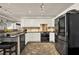 Bright kitchen featuring white cabinets, stainless steel appliances, and dark countertops at 4320 Oklahoma Nw Way, Kennesaw, GA 30152