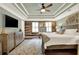 The main bedroom boasts a decorative wood wall, tray ceiling and stylish decor at 4320 Oklahoma Nw Way, Kennesaw, GA 30152