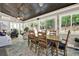 Bright sunroom with dining table, ceiling fan, and views of the private wooded backyard at 4320 Oklahoma Nw Way, Kennesaw, GA 30152