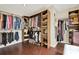 Spacious walk-in closet featuring custom shelving, double-hanging rods and hardwood floors at 4320 Oklahoma Nw Way, Kennesaw, GA 30152