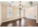 Elegant dining room featuring hardwood floors, coffered ceiling and a modern chandelier at 46 Grand Georgian Ne Ct, Cartersville, GA 30121