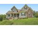 Charming two-story home boasting complementary siding, stone accents and a welcoming front porch at 46 Grand Georgian Ne Ct, Cartersville, GA 30121