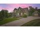 Inviting two-story home featuring stone accents, complementary siding and a detached garage at 46 Grand Georgian Ne Ct, Cartersville, GA 30121